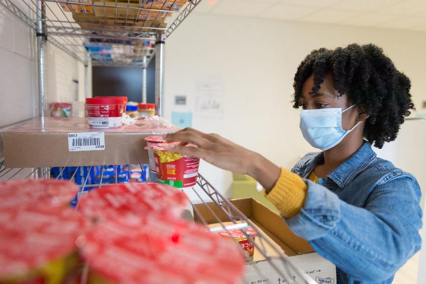 Brandywine student Angel Asomugha stocking the campus food pantry. 